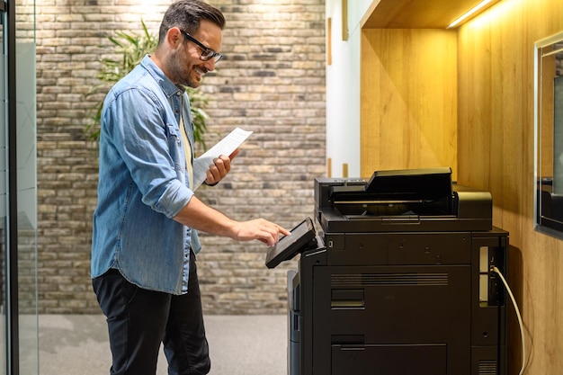 side view smiling male professional holding documents using photocopying machine office 891700 3610